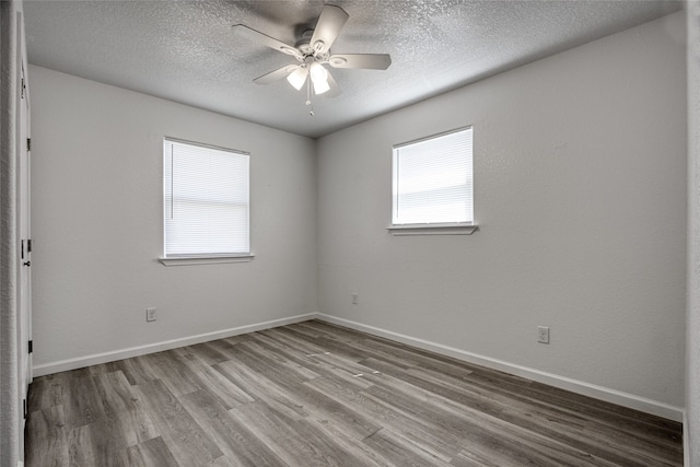 empty room featuring a textured ceiling, light hardwood / wood-style floors, and ceiling fan