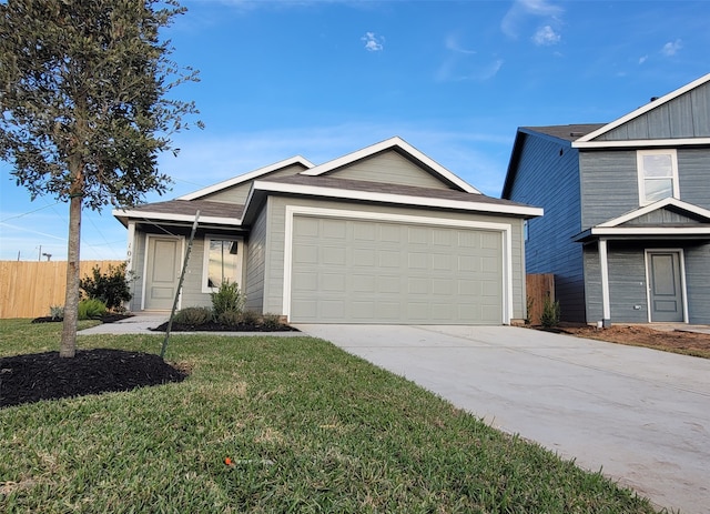 view of front of home with a garage and a front lawn