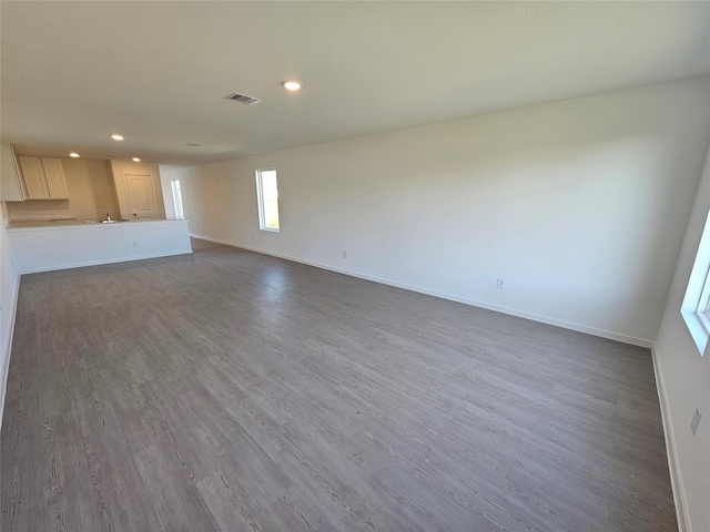 unfurnished living room with dark hardwood / wood-style floors