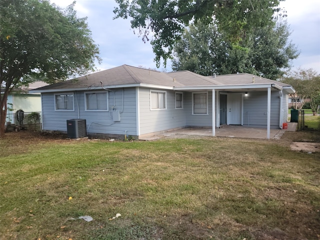 ranch-style house featuring cooling unit, a patio area, and a front yard