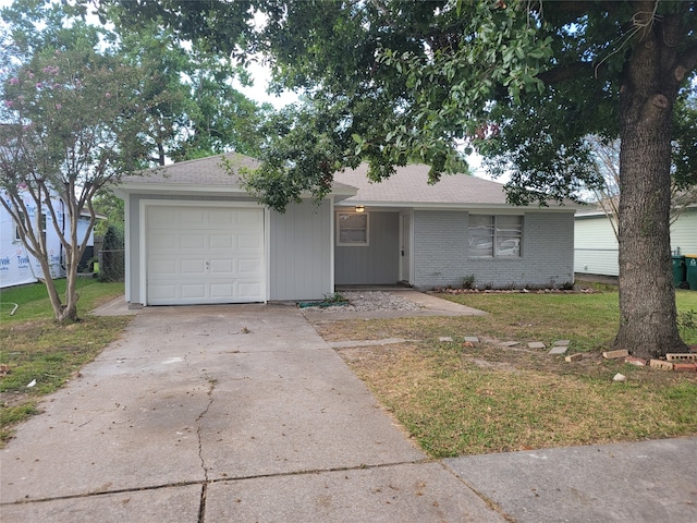 ranch-style house featuring a front yard and a garage