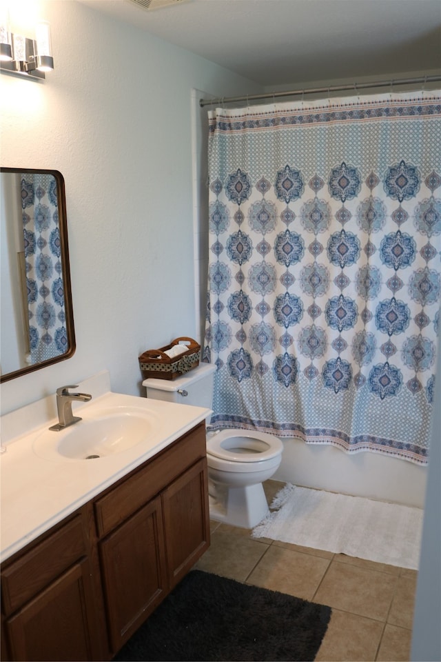 full bathroom with tile patterned floors, shower / bath combo, vanity, and toilet