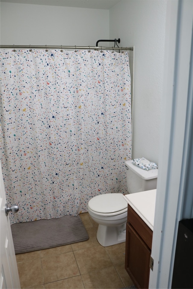 bathroom with vanity, tile patterned flooring, toilet, and a shower with shower curtain