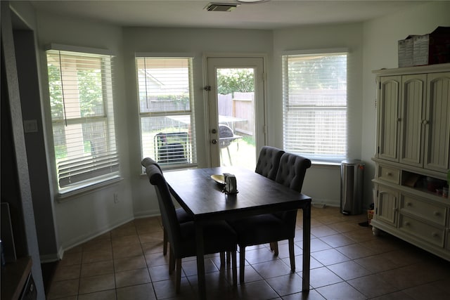 dining area with dark tile patterned floors