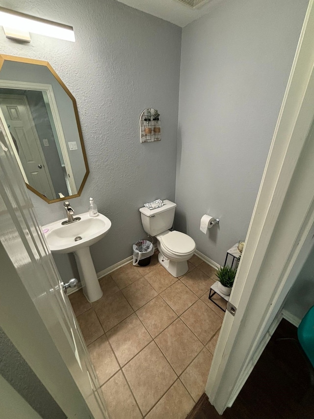 bathroom featuring tile patterned flooring and toilet