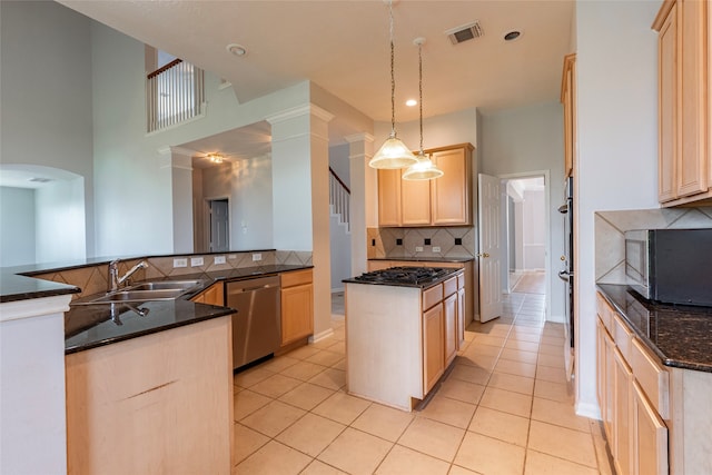 kitchen featuring sink, pendant lighting, light brown cabinets, and stainless steel appliances