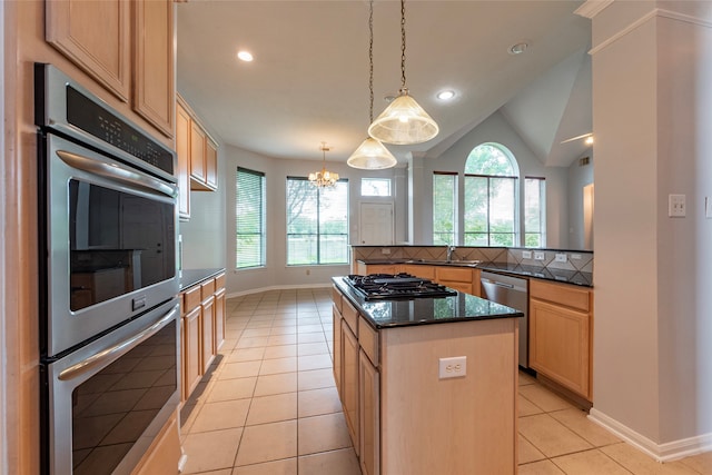 kitchen with tasteful backsplash, stainless steel appliances, vaulted ceiling, decorative light fixtures, and light tile patterned floors