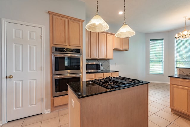 kitchen featuring a kitchen island, hanging light fixtures, light tile patterned floors, light brown cabinetry, and appliances with stainless steel finishes