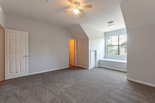 bonus room featuring carpet floors, a textured ceiling, vaulted ceiling, and ceiling fan