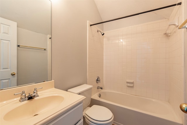 full bathroom featuring toilet, tiled shower / bath, and vanity