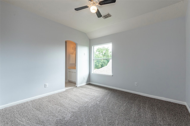 empty room with lofted ceiling, light colored carpet, and ceiling fan