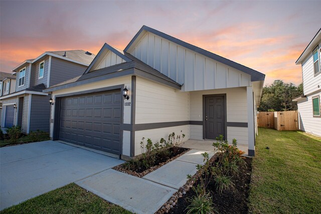 view of front of home with a yard and a garage