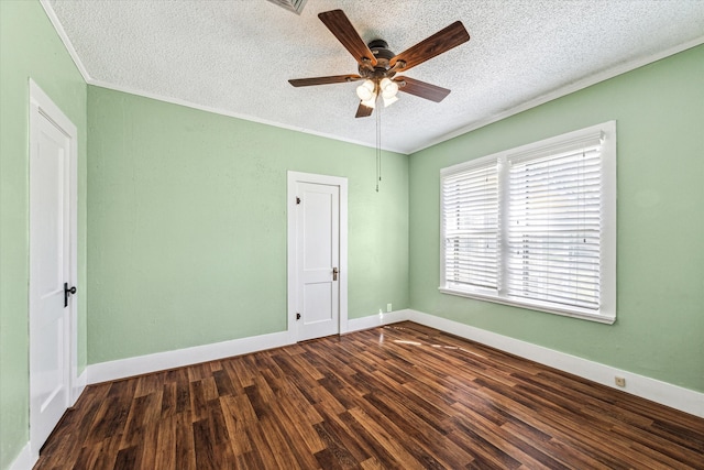 spare room with ceiling fan, ornamental molding, a textured ceiling, and dark hardwood / wood-style flooring