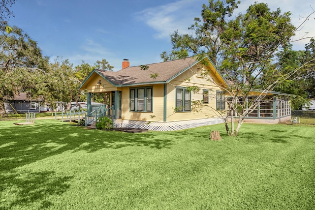 rear view of house with a yard