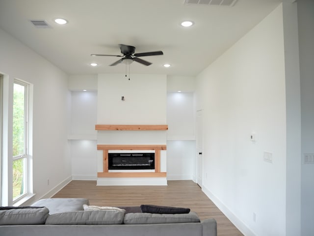 living room featuring hardwood / wood-style floors and ceiling fan