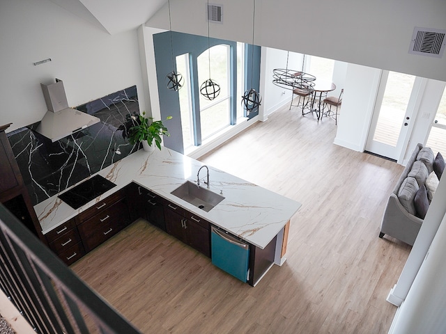 living room with vaulted ceiling, light hardwood / wood-style flooring, and sink