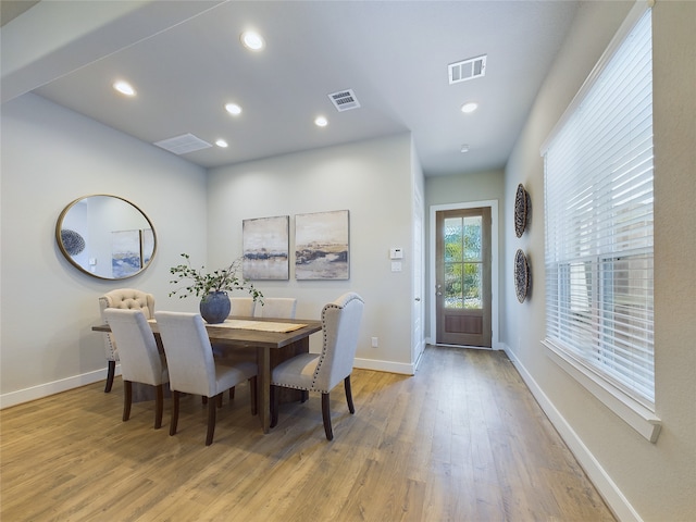 dining space with light hardwood / wood-style floors