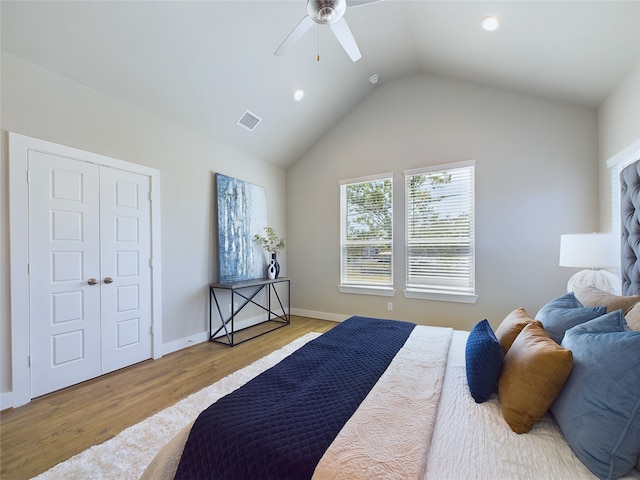 bedroom with ceiling fan, vaulted ceiling, light hardwood / wood-style flooring, and a closet