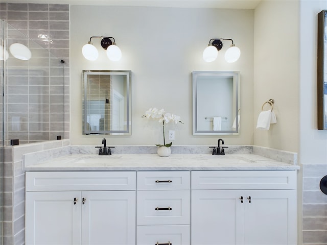 bathroom featuring walk in shower and vanity