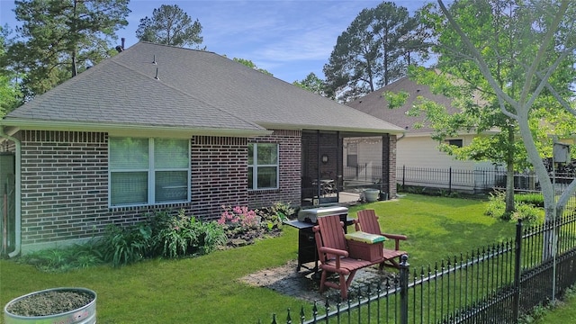 rear view of house with a lawn