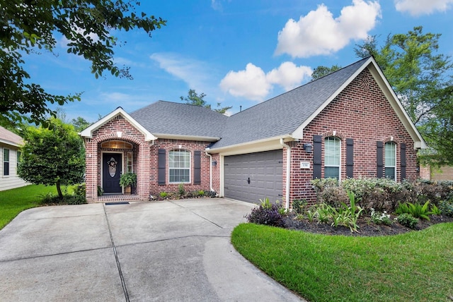 view of front of home featuring a garage and a front lawn