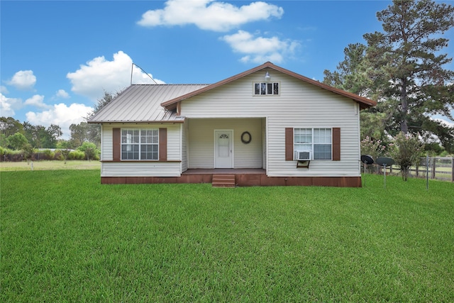 view of front facade featuring cooling unit and a front lawn