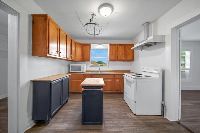 kitchen featuring dark hardwood / wood-style floors, sink, white appliances, and a kitchen island