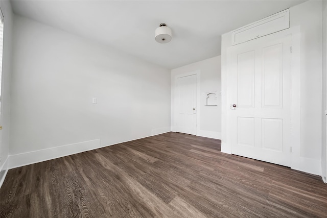 empty room featuring dark hardwood / wood-style flooring