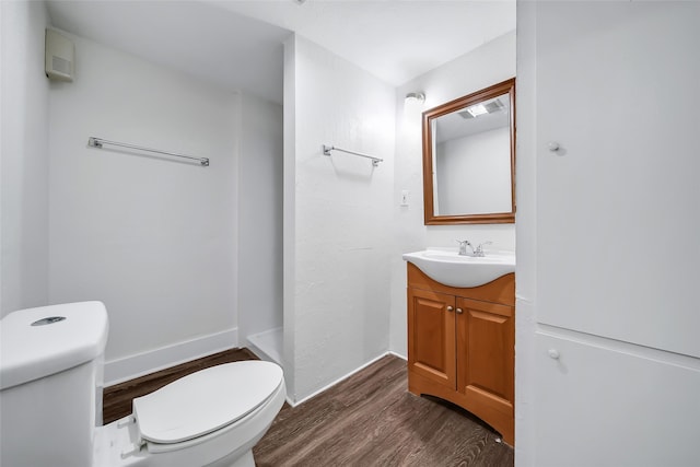 bathroom featuring vanity, toilet, and hardwood / wood-style flooring