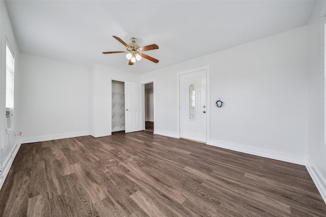 interior space with ceiling fan and dark hardwood / wood-style flooring