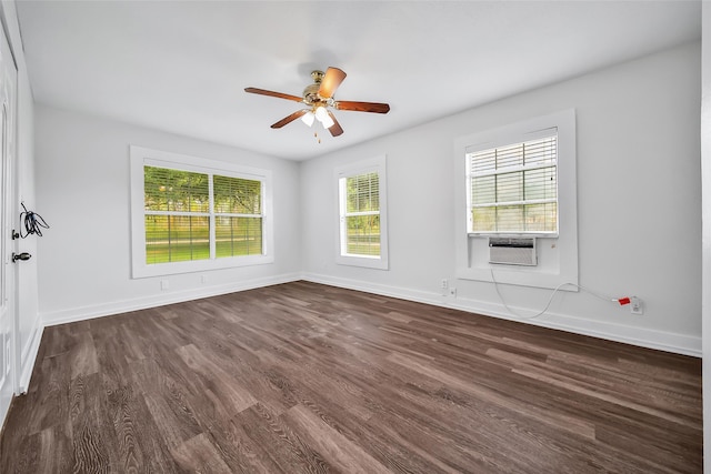 spare room featuring ceiling fan, cooling unit, plenty of natural light, and dark hardwood / wood-style flooring