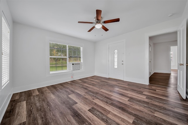 interior space featuring cooling unit, dark hardwood / wood-style floors, and ceiling fan