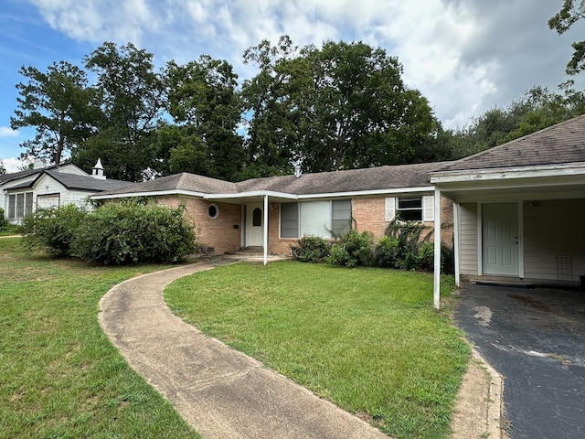 ranch-style home with a carport and a front lawn