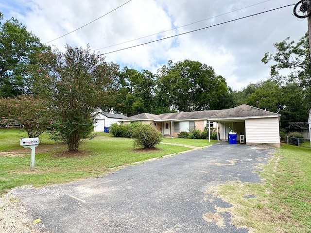 single story home featuring a carport and a front lawn