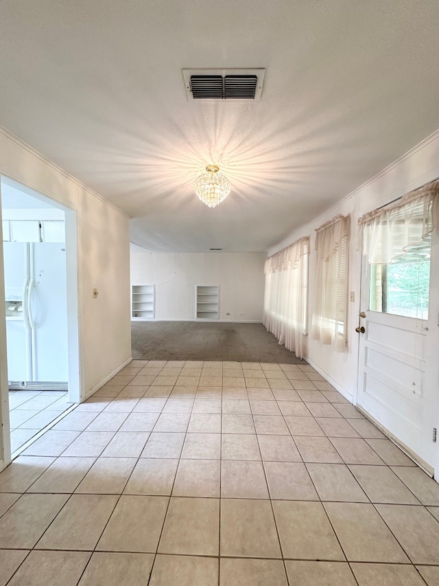 tiled spare room with ornamental molding