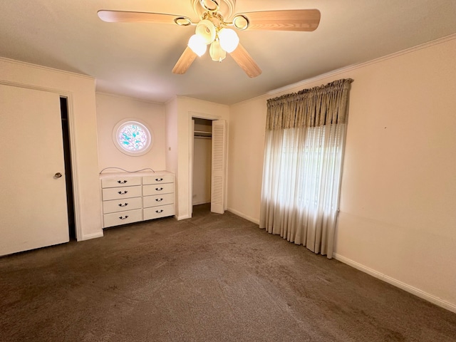 unfurnished bedroom featuring dark colored carpet, ceiling fan, and crown molding