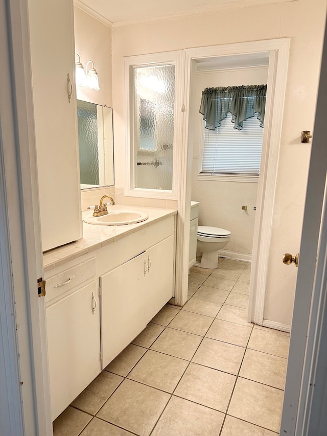 bathroom with tile patterned flooring, vanity, and toilet