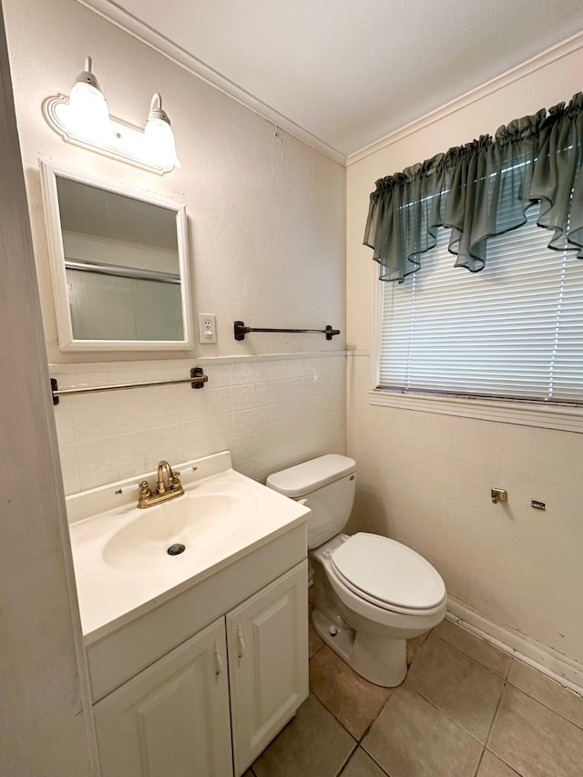 bathroom with vanity, tile walls, toilet, and tile patterned floors