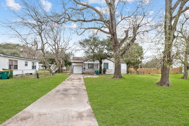 view of front of property with a garage and a front lawn