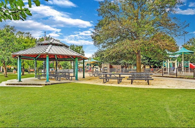 view of property's community featuring a playground, a gazebo, and a yard