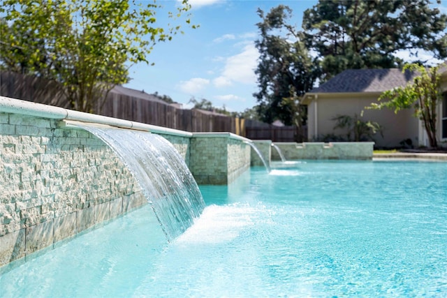 view of swimming pool featuring pool water feature