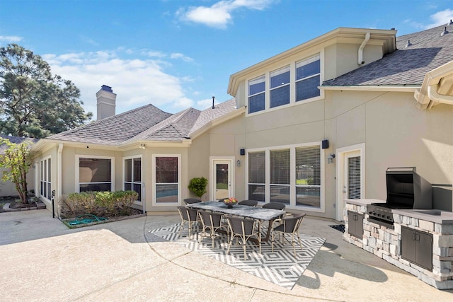 rear view of property with area for grilling and a patio