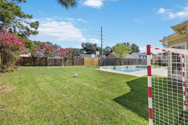 view of yard with a fenced in pool