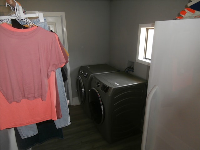 washroom featuring dark hardwood / wood-style flooring and washing machine and clothes dryer