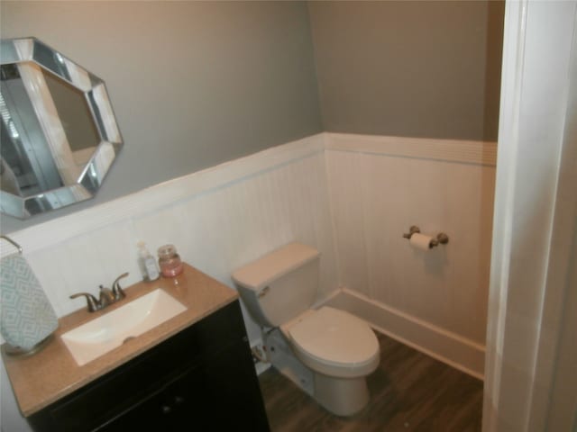 bathroom featuring hardwood / wood-style floors, vanity, and toilet