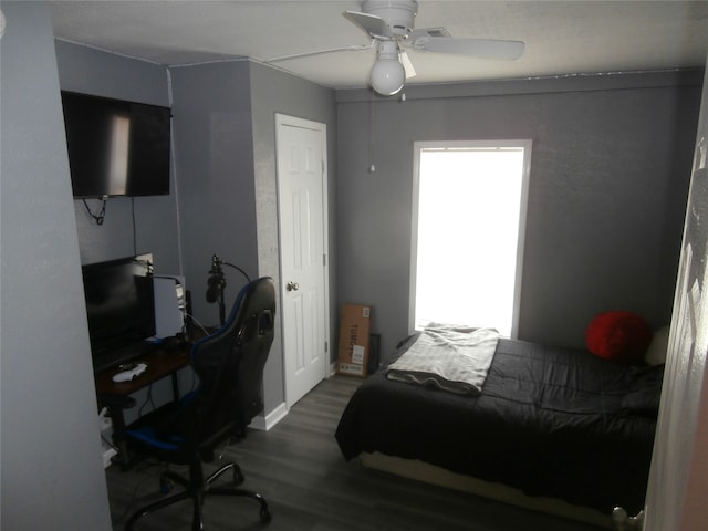 bedroom with ceiling fan and dark wood-type flooring