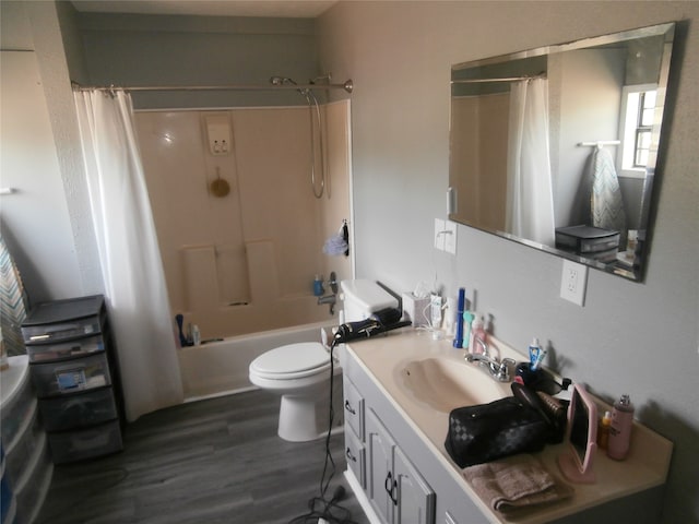 full bathroom featuring hardwood / wood-style floors, shower / bathtub combination with curtain, toilet, and vanity