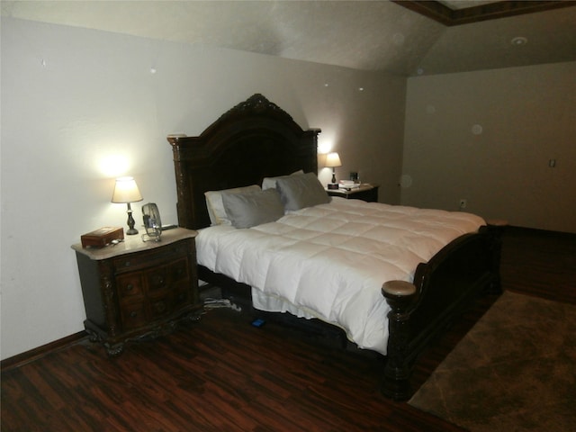 bedroom featuring vaulted ceiling and dark hardwood / wood-style floors