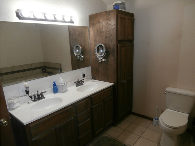 bathroom with vanity, tile patterned flooring, and toilet