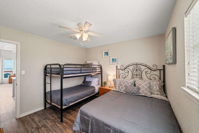 bedroom featuring a textured ceiling, wood-type flooring, and ceiling fan